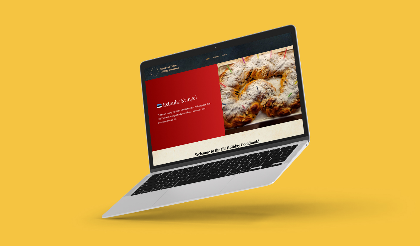 A laptop with a cookbook website open, showcasing a delicious pastry recipe for the holiday, against a vibrant yellow background.
