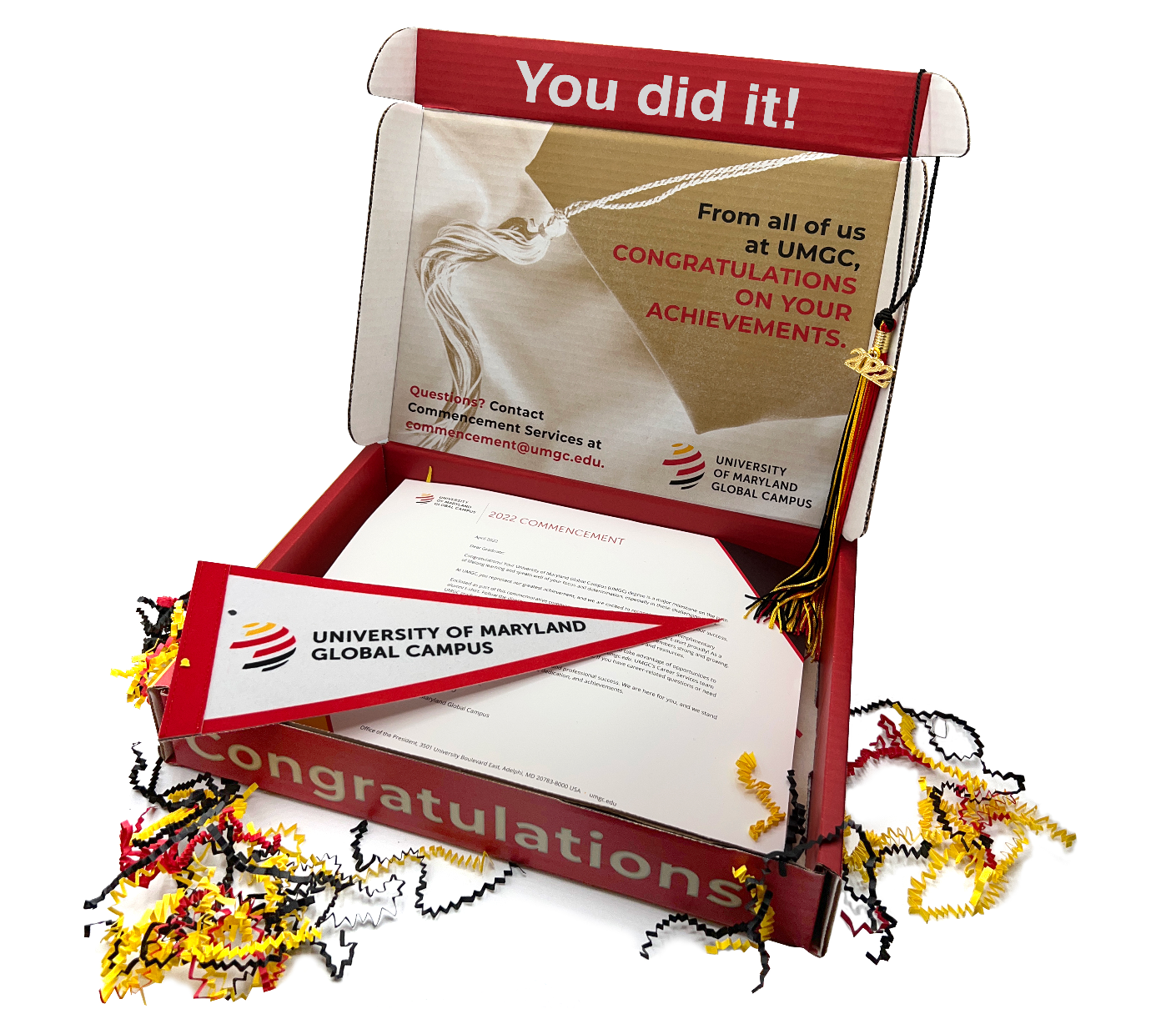 An open graduation-themed greeting card from the University of Maryland Global Campus with the message "You did it, graduate!" displayed on the mosaic-decorated card, surrounded by celebratory confetti.