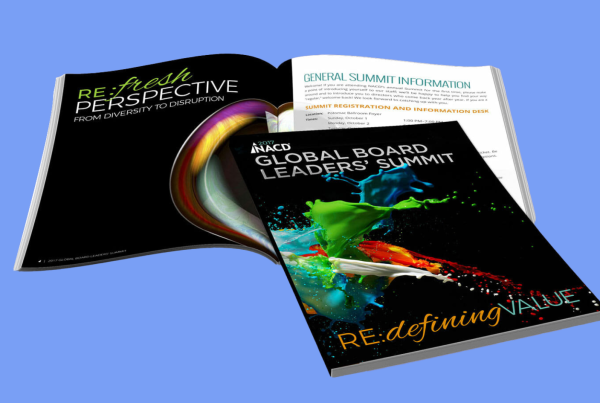 An open brochure for the NACD Global Board Leaders' Summit featuring vibrant, abstract artwork and the theme "re:defining value".