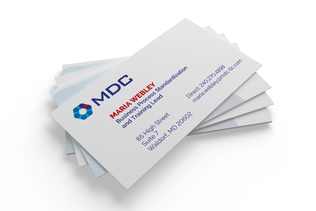 A stack of professional business cards for Maria Bevel, Business Planning Lead at MDC, with contact information and brand development logo displayed.